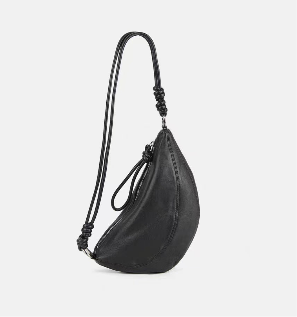 Genuine leather crescent saddle bag with adjustable strap, sleek black design.