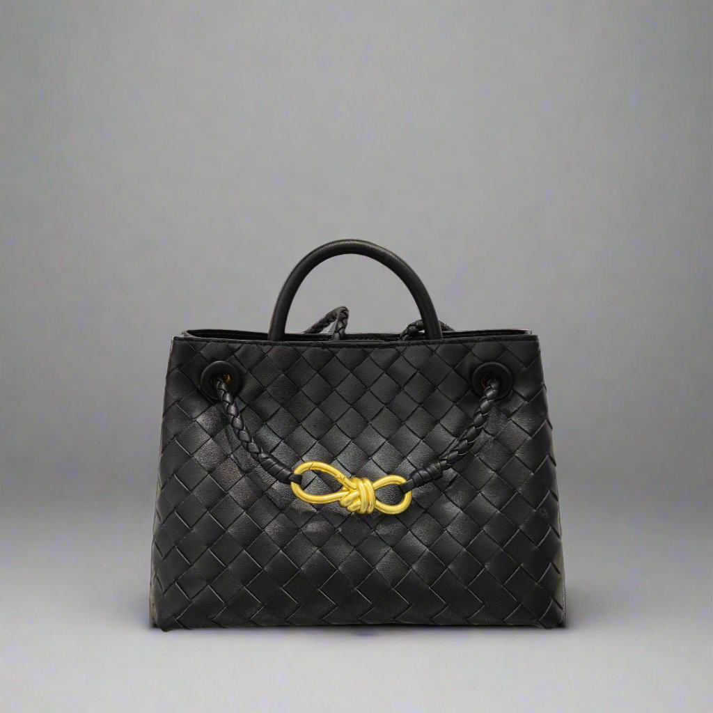 Jade crosswoven leather shoulder bag with dual compartments and gold accent.