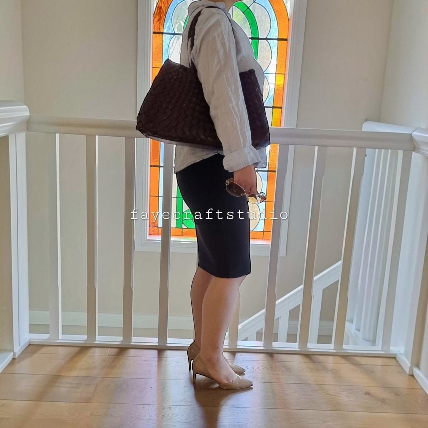 Model side View Of Leah Large Handmade Leather Woven Tote Bag with Long Handles in Coffee Leather