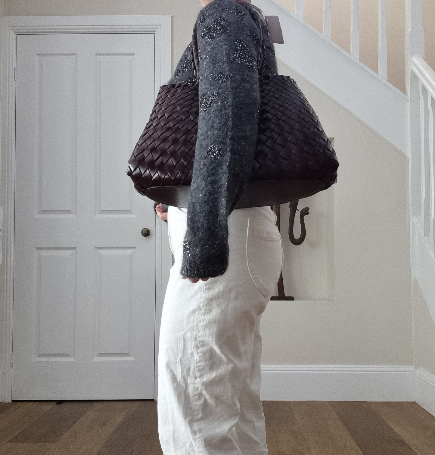 Leah City Zip coffee woven leather tote bag carried on shoulder, showing long handles and spacious structured shape