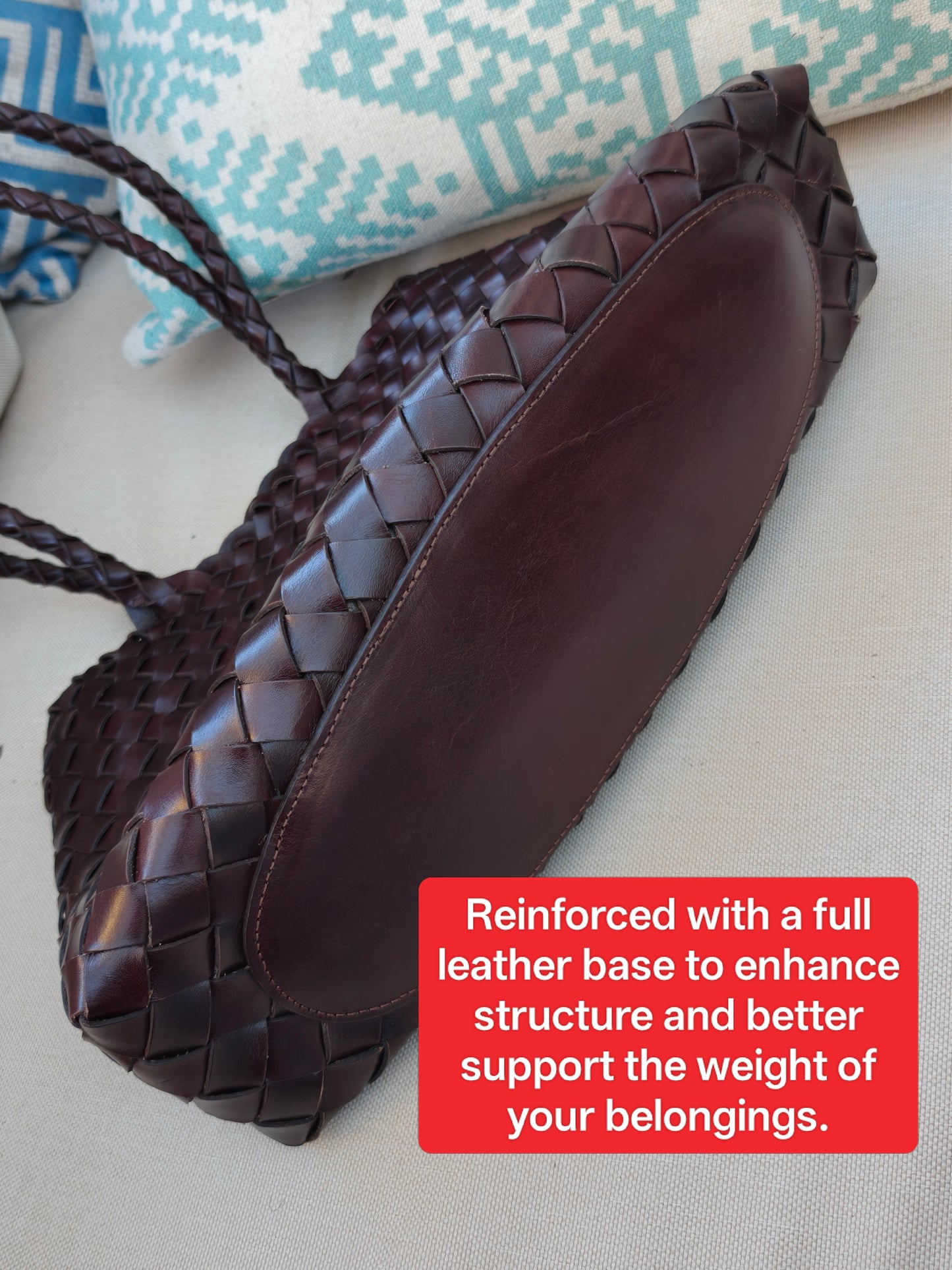Bottom view of Leah City Zip brown woven leather tote showing full leather panel construction