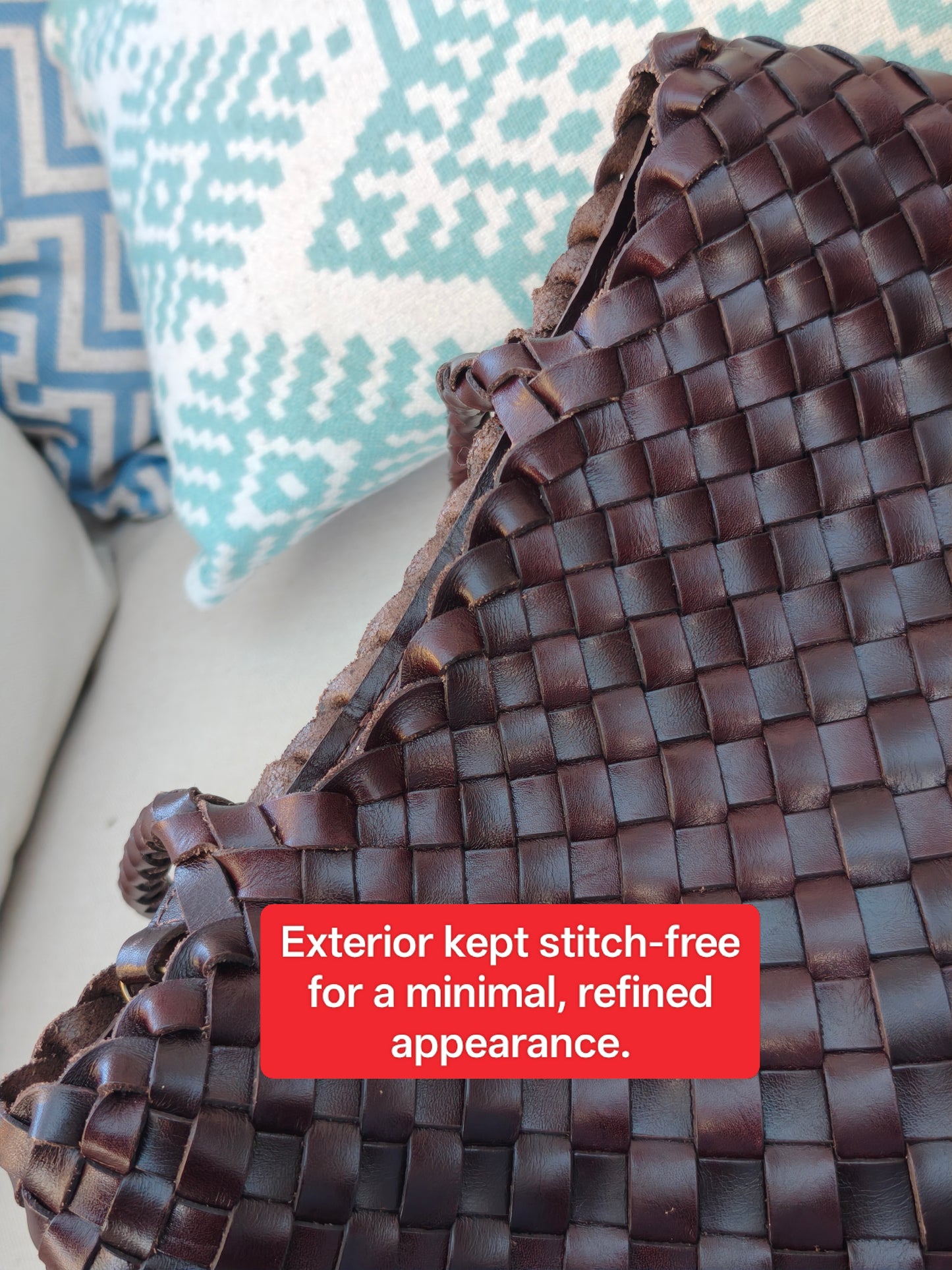 Close-up of Leah City Zip coffee woven leather tote showing stitch-free exterior for a minimal refined look