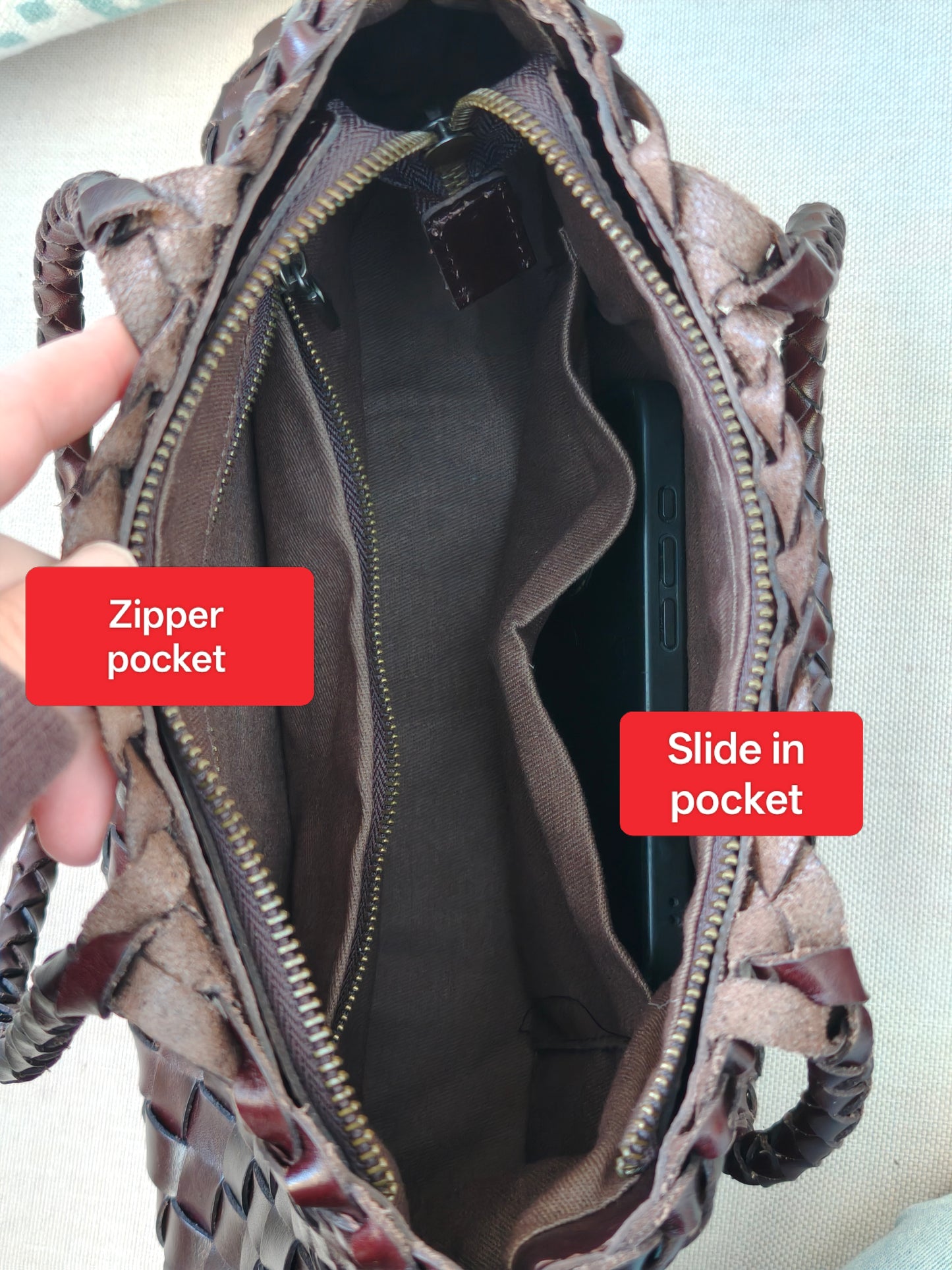 Leah City Zip coffee woven leather tote bag unzipped to show interior with side pockets