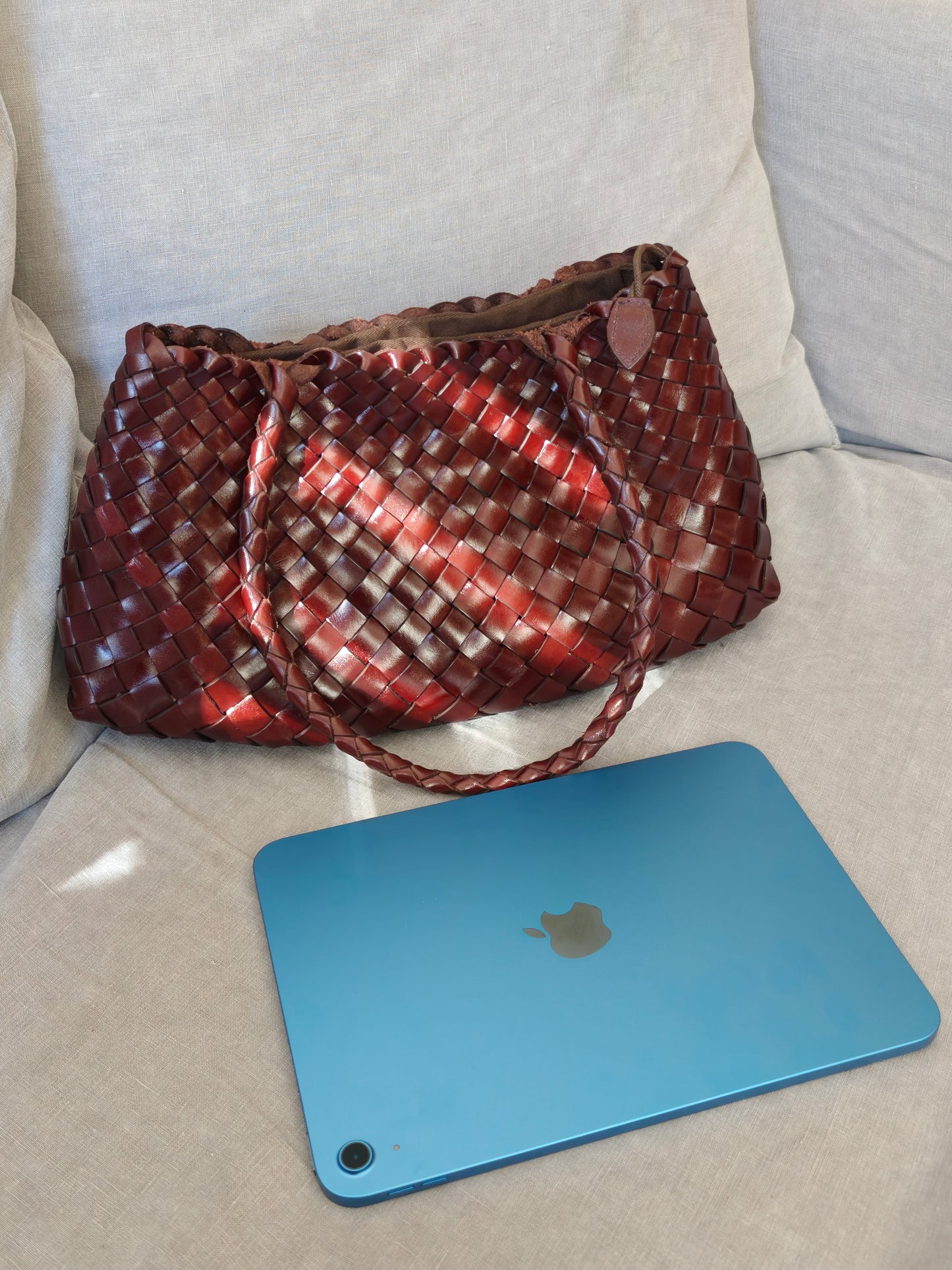 Opal City Zip woven leather tote bag next to 11-inch iPad showing size comparison