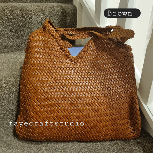 Brown top layer cowhide leather woven bag with soft, durable texture and braided handles