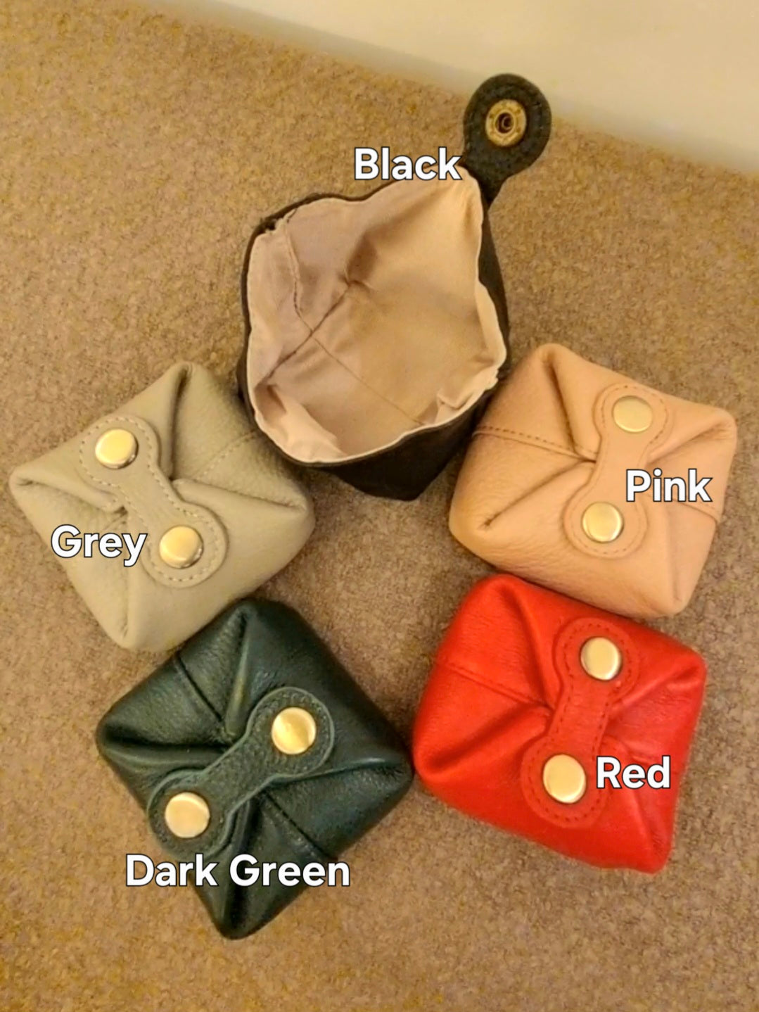 Abby genuine leather coin purses in black, pink, grey, dark green, and red.