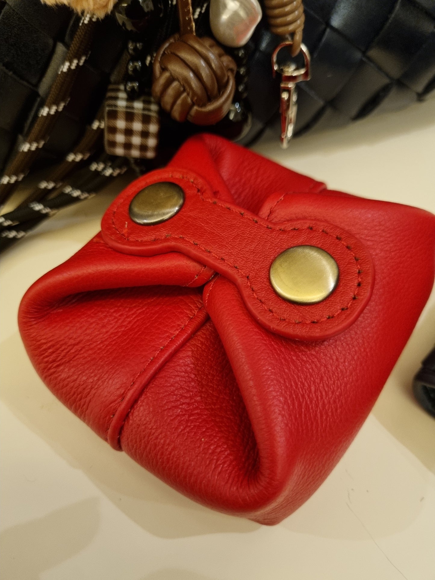 Red Abby genuine leather square coin purse with button details.