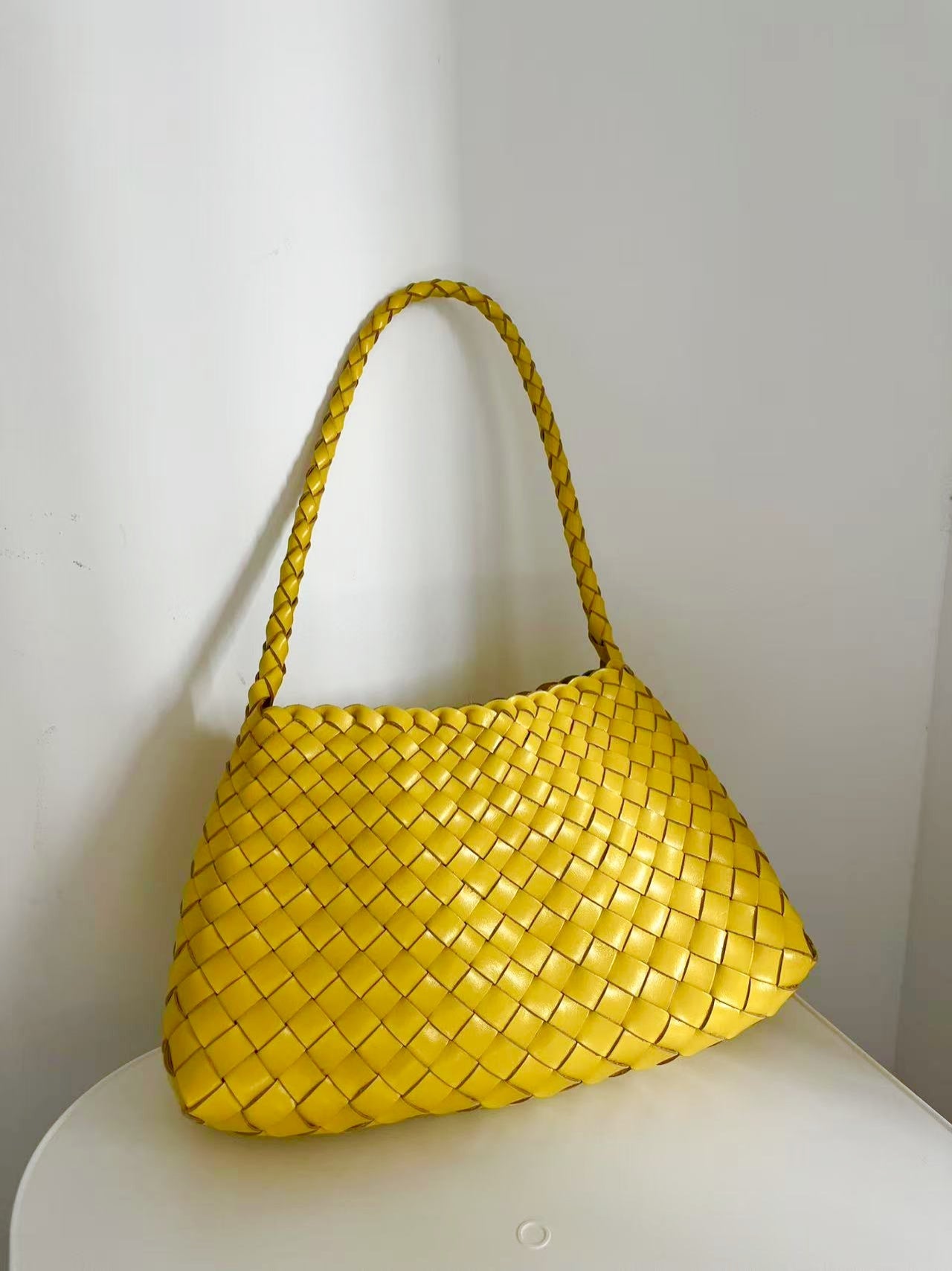 Handwoven yellow cowhide leather shoulder bag from the 2025 Summer Colour Collection.