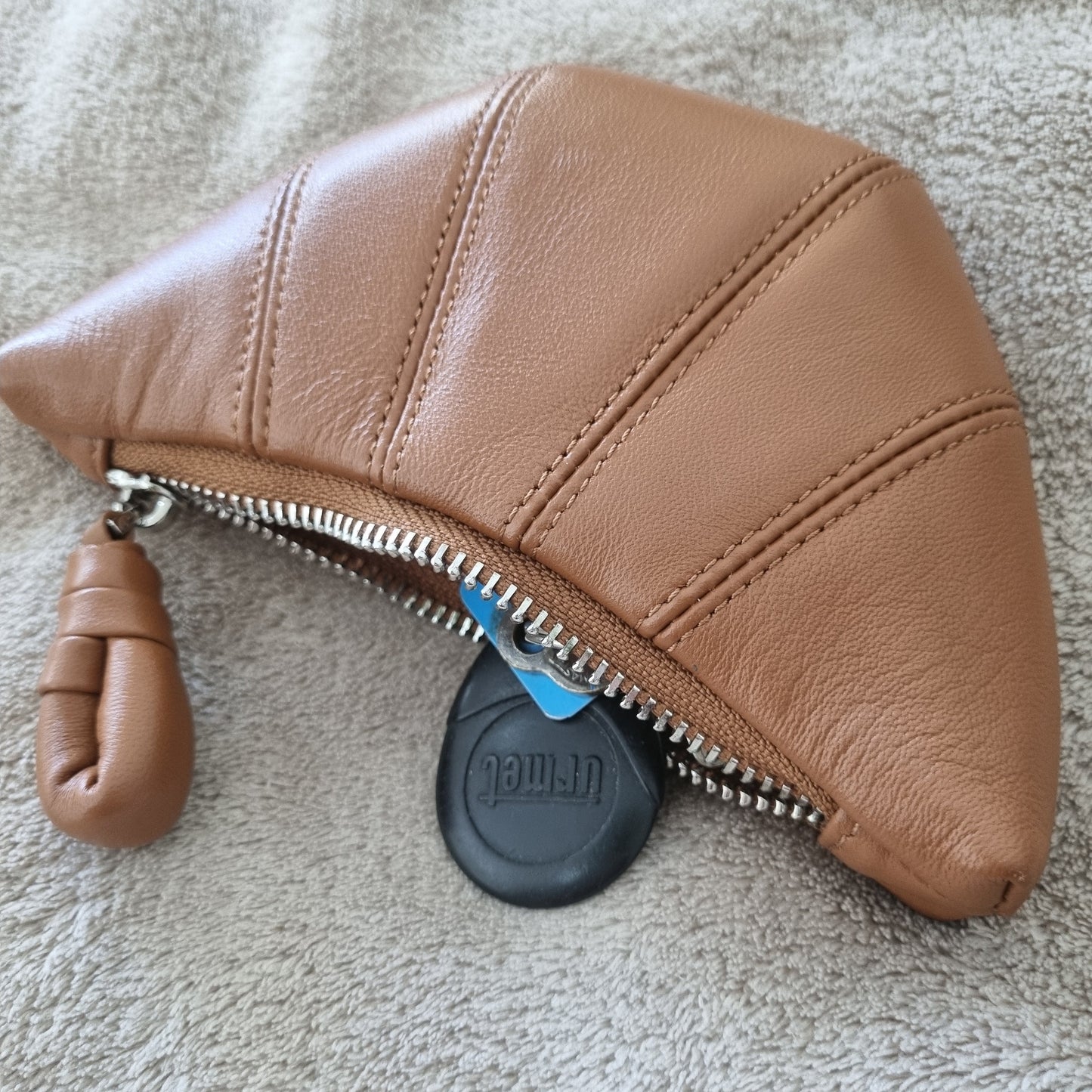 Sheepskin Mini Crescent Coin Purse in caramel color with zipper compartment, crafted from soft lambskin.