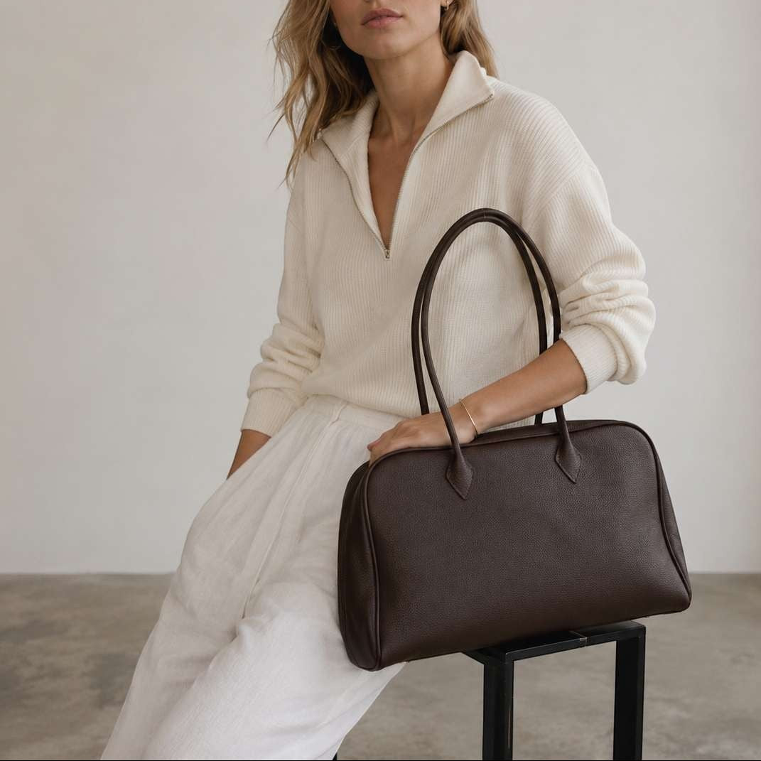 Belle Coffee  full-grain leather shoulder bag worn by model in soft neutral studio setting
