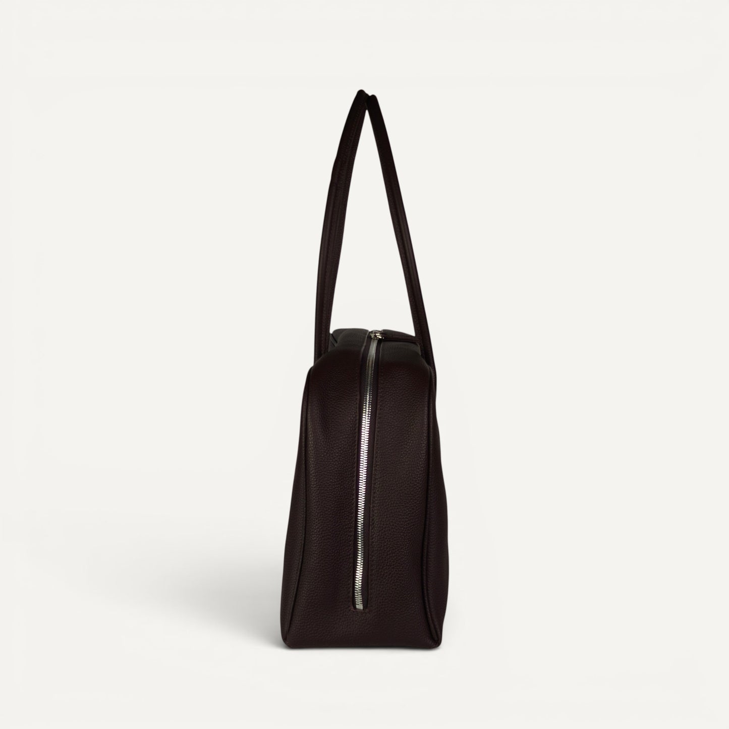 Side profile of Belle espresso brown full-grain leather shoulder bag with elongated double straps and top zip closure