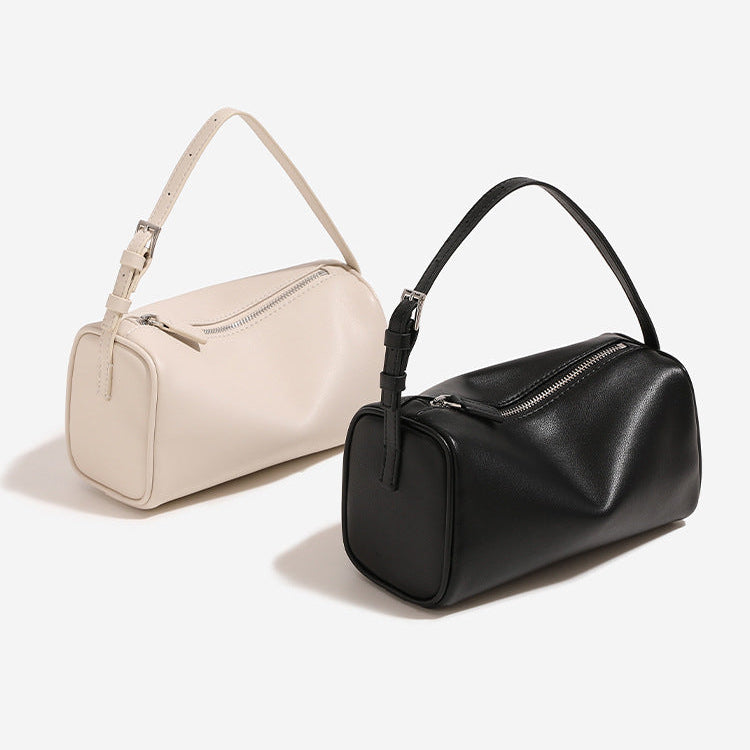 Two handbags, one beige and one black, on a light gray background.