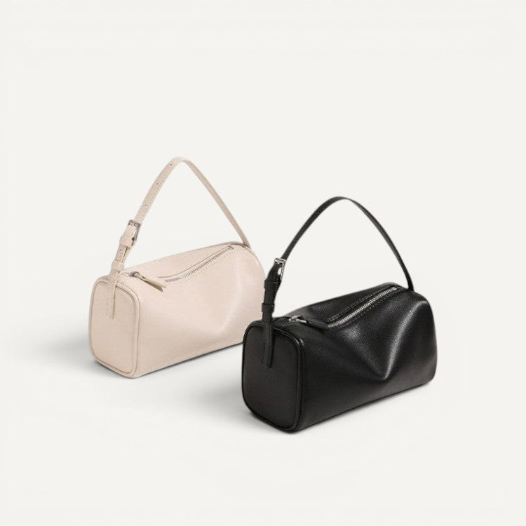Two handbags, one beige and one black, on a light gray background.