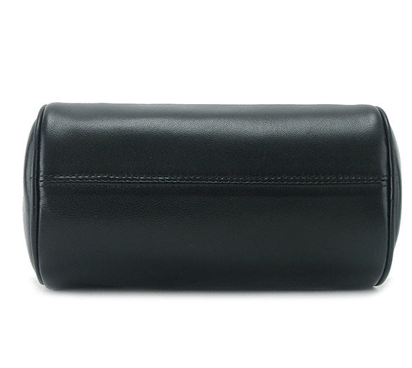 Minimalist genuine leather cylinder bag, sleek design, elegant black finish.