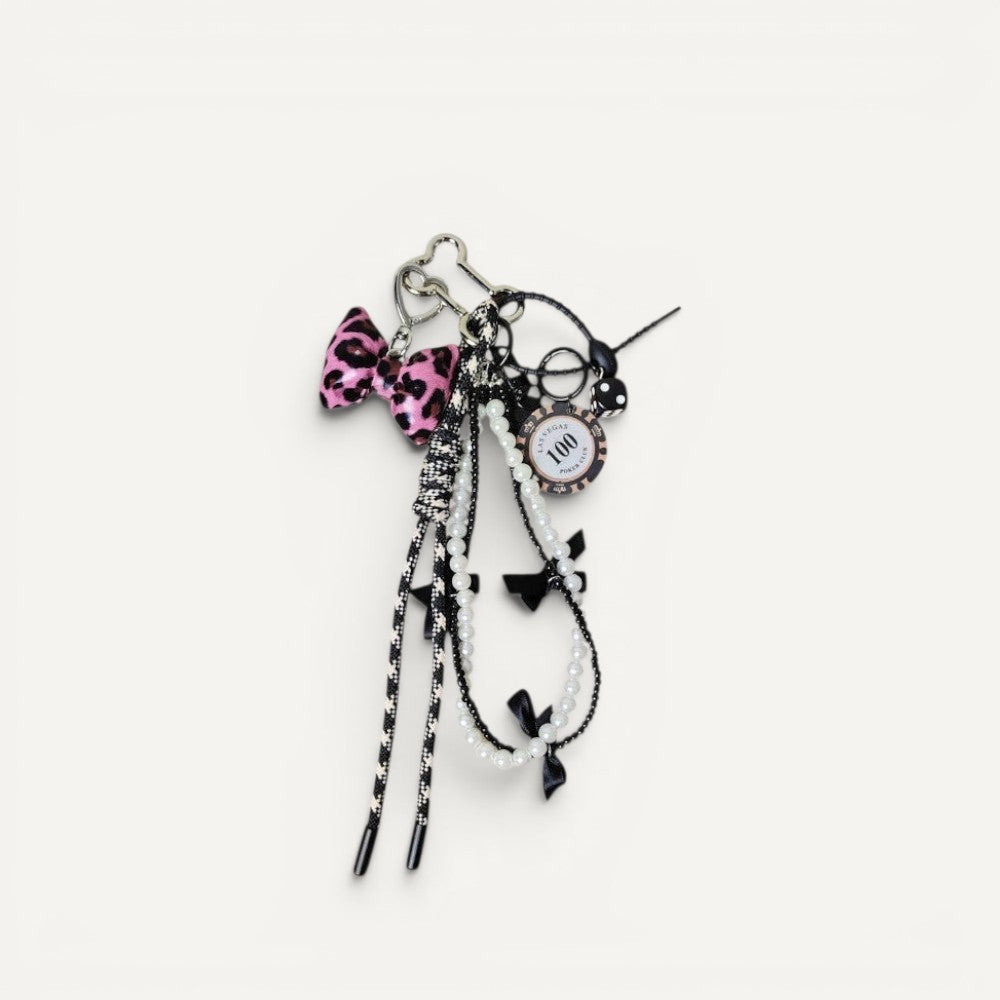 Fiona Luxe Charm pink leopard bow keychain with pearl accents and rope details on faux leather