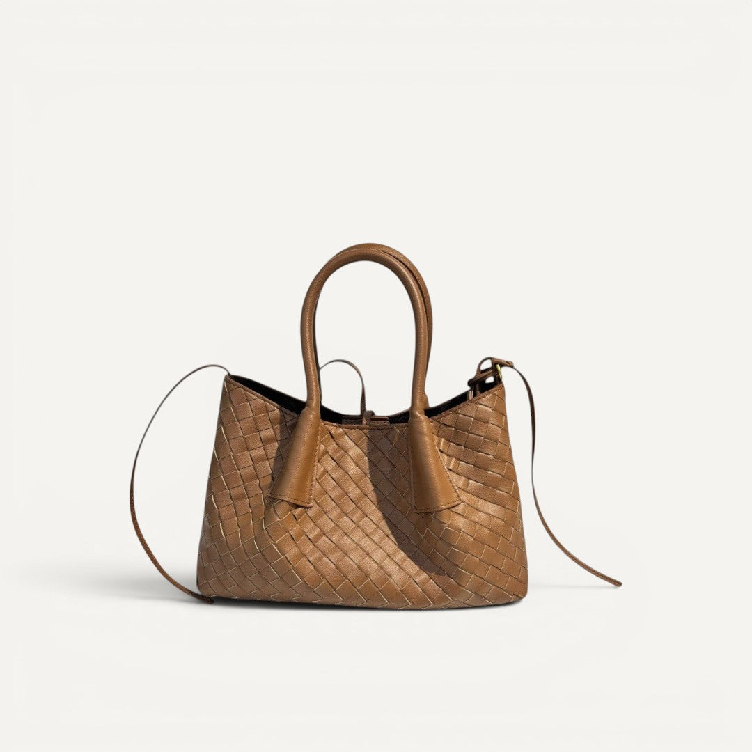 Brown woven handbag on a white background