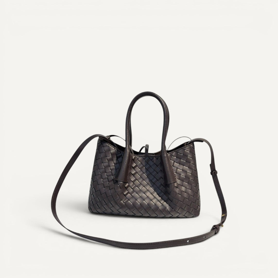 Dark brown woven handbag with a shoulder strap on a white background
