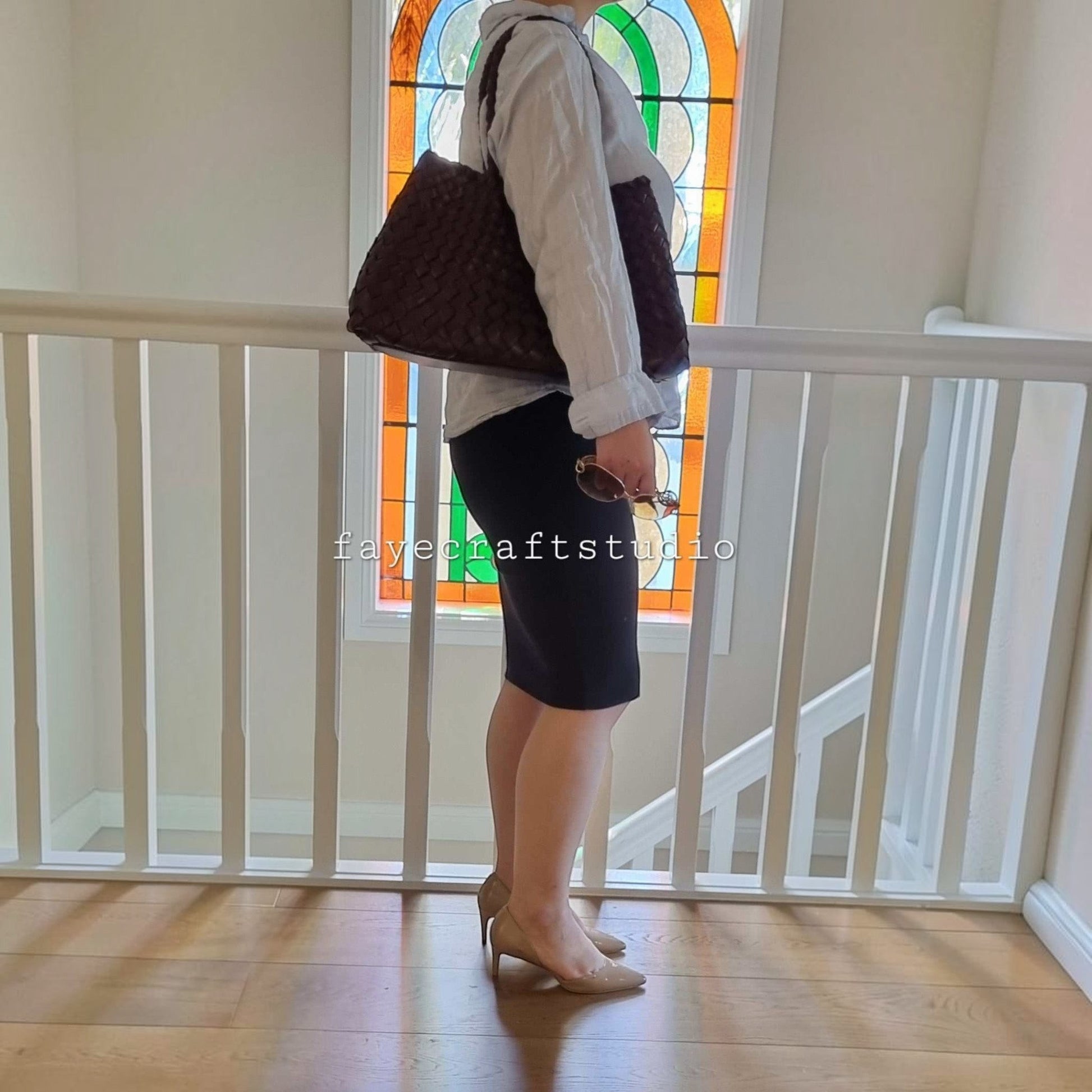Model side View Of Leah Large Handmade Leather Woven Tote Bag with Long Handles in Coffee Leather