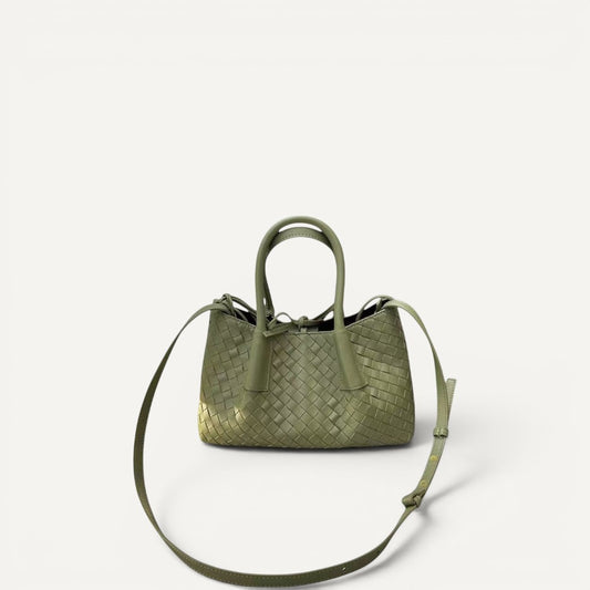 Green woven handbag with a strap on a white background