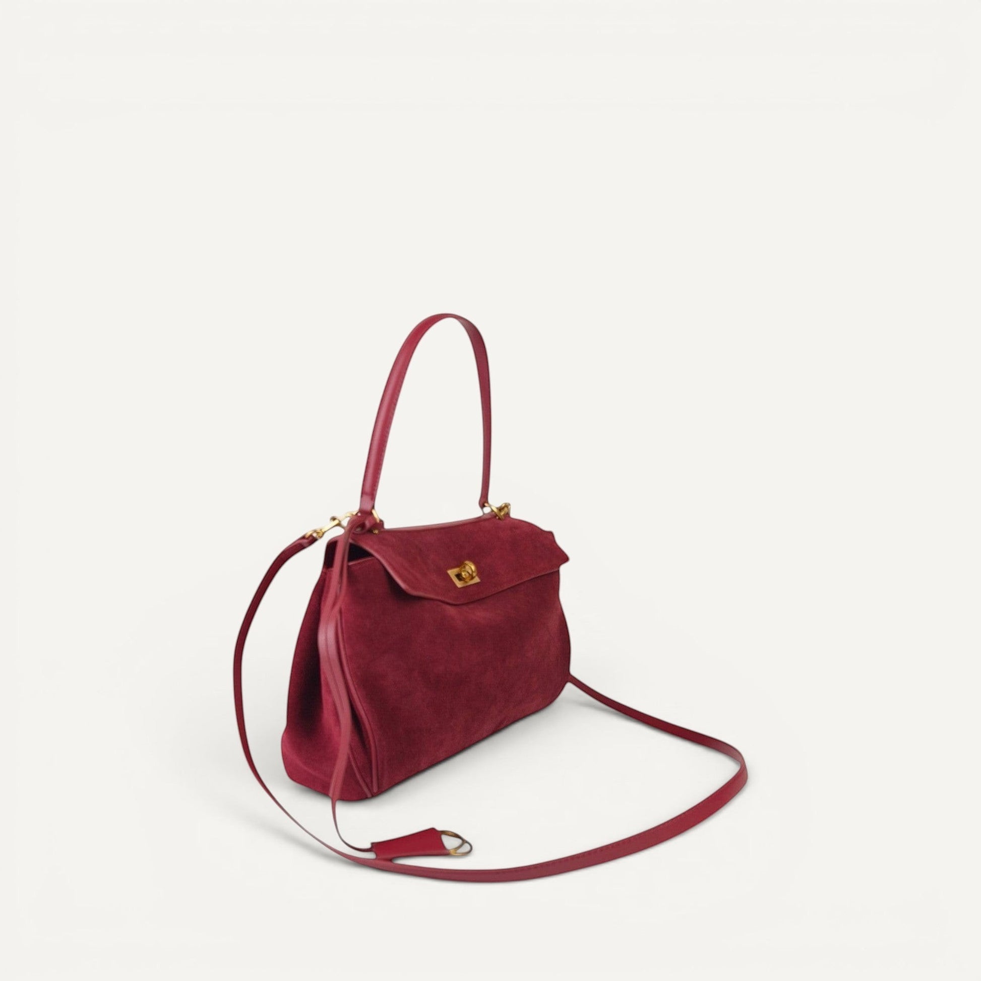 burgundy harper small handbag with a strap on a white background