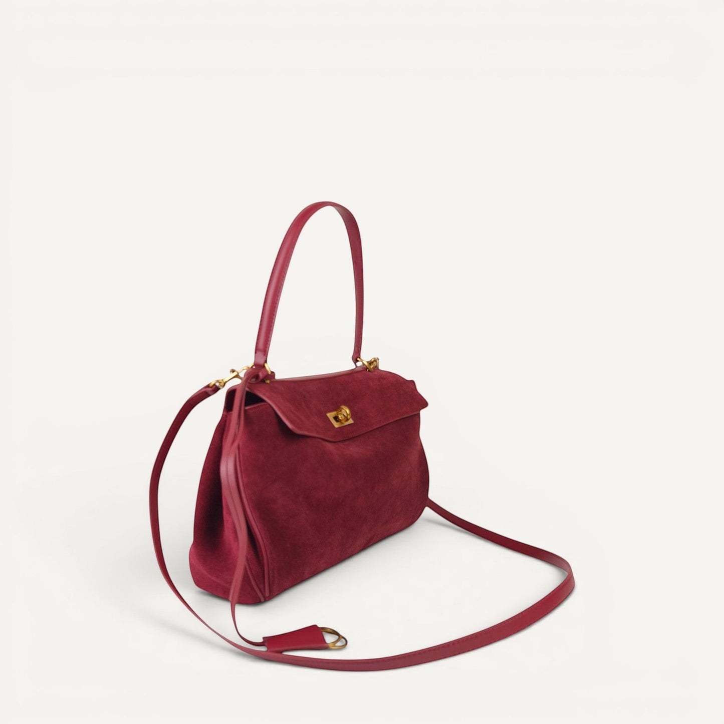 burgundy harper small handbag with a strap on a white background