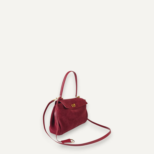 burgundy harper small handbag with a strap on a white background
