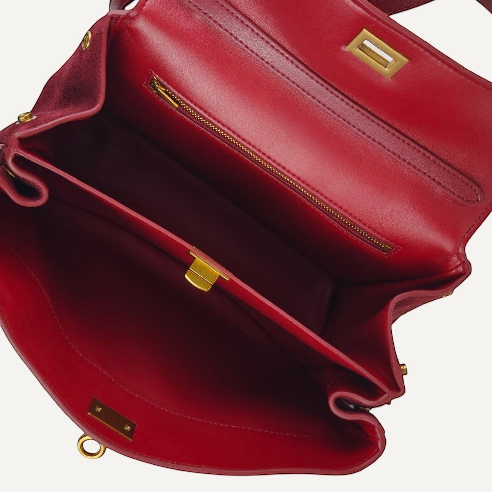 Red handbag with gold accents on a white background