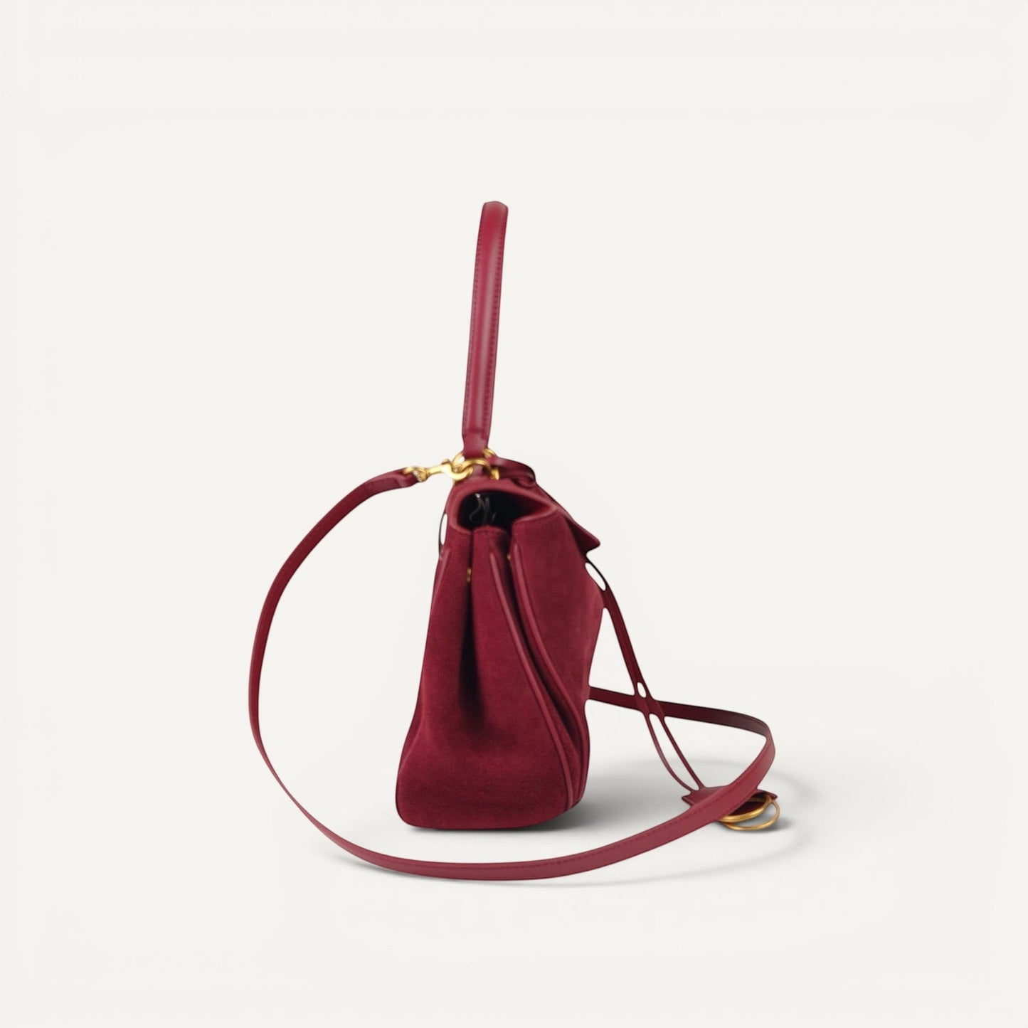 burgundy handbag with a strap on a white background