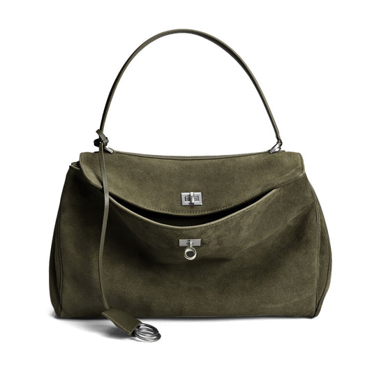 Green suede harper handbag with a strap on a white background