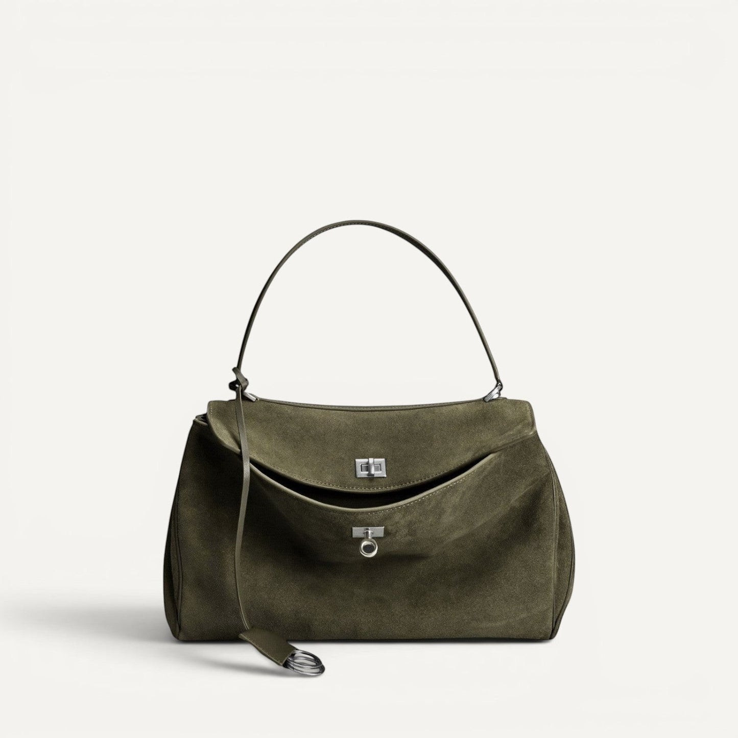 Green suede harper handbag with a strap on a white background