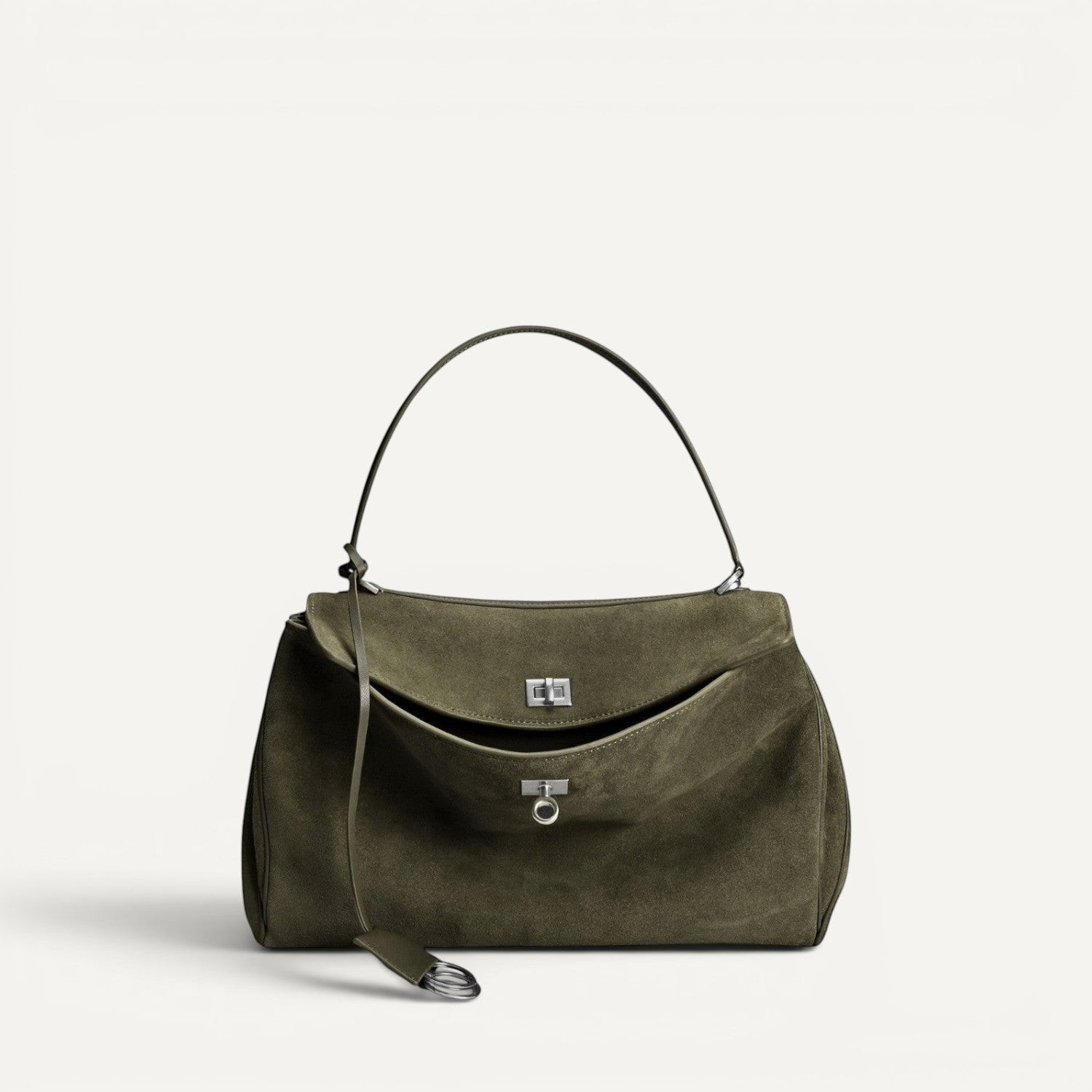 Green suede harper handbag with a strap on a white background