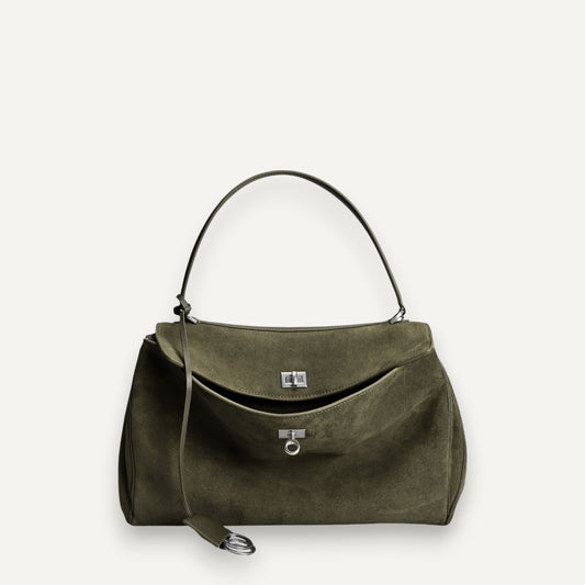 Green suede harper handbag with a strap on a white background