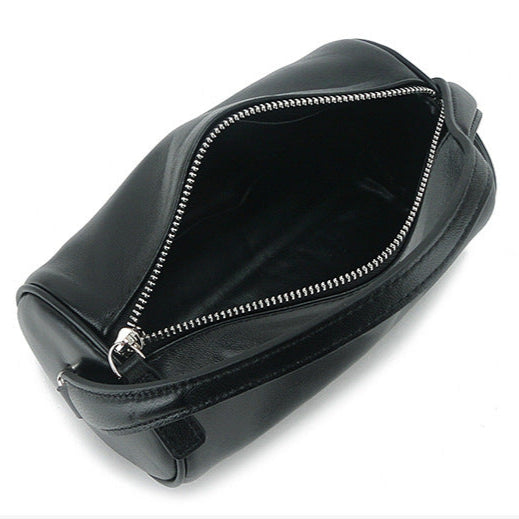 Minimalist genuine leather cylinder bag with zipper closure.