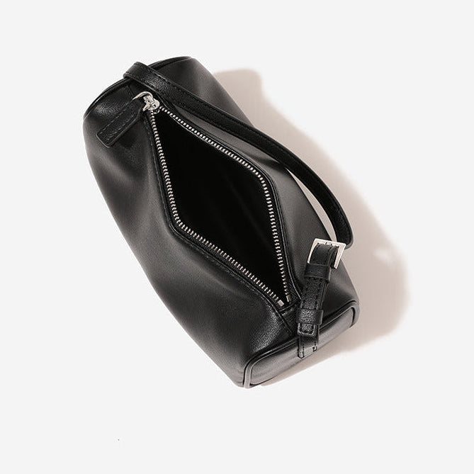 Black leather bag with a zipper on a white background