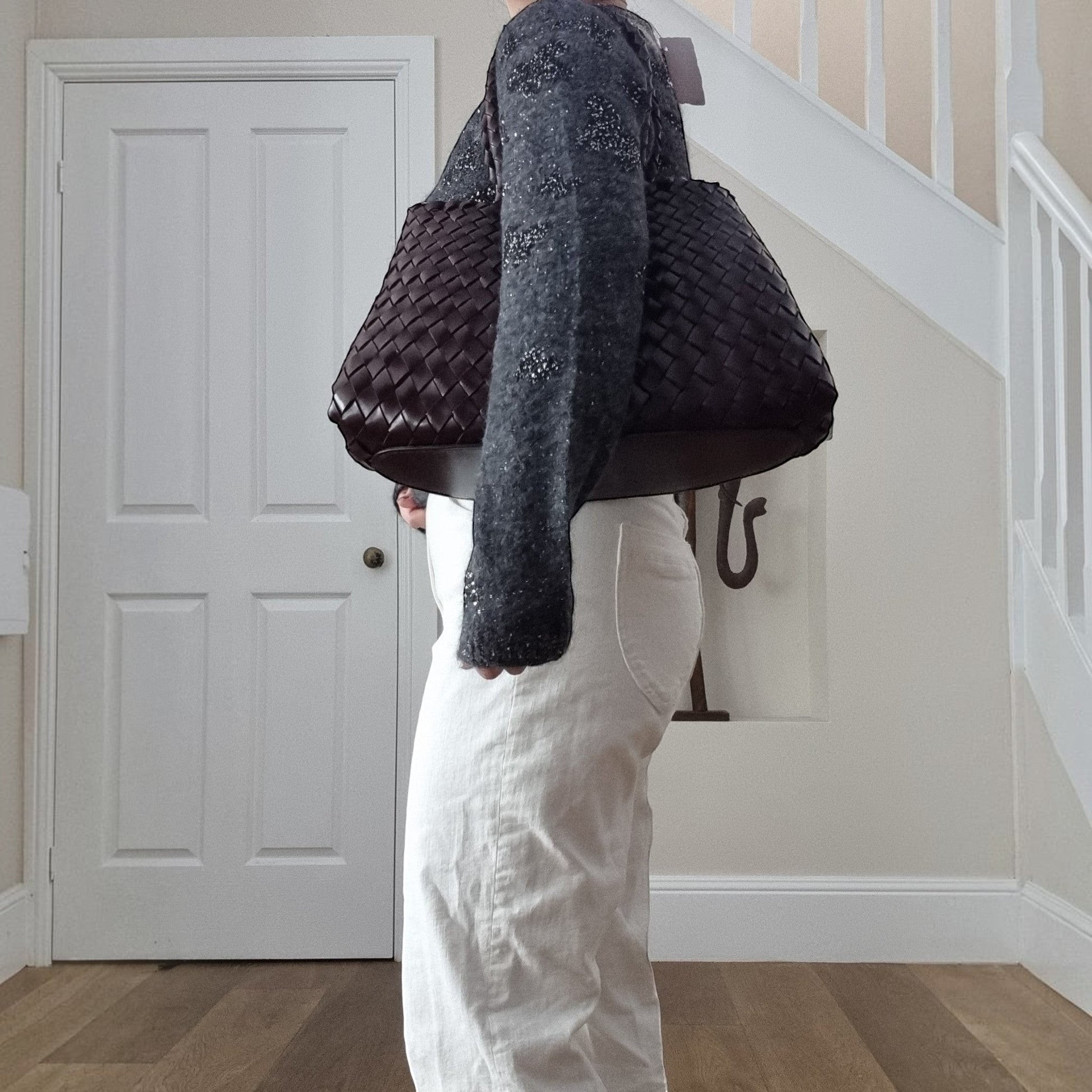 Leah City Zip coffee woven leather tote bag carried on shoulder, showing long handles and spacious structured shape