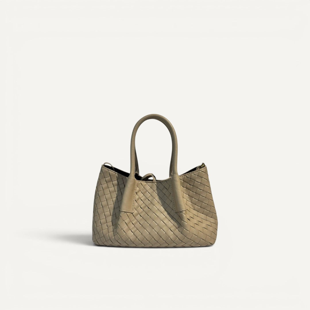 Beige woven handbag on a white background