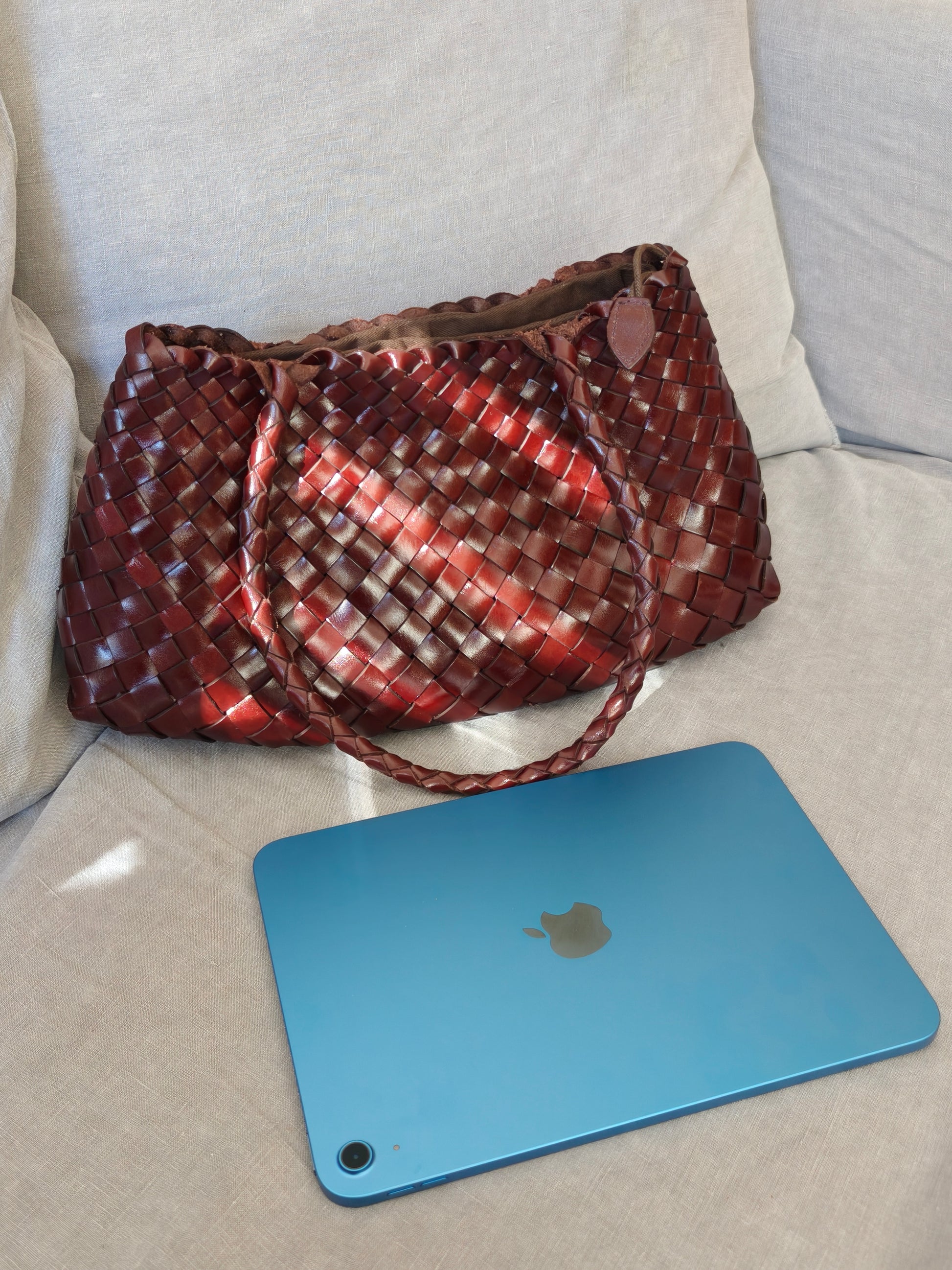 Opal City Zip woven leather tote bag next to 11-inch iPad showing size comparison