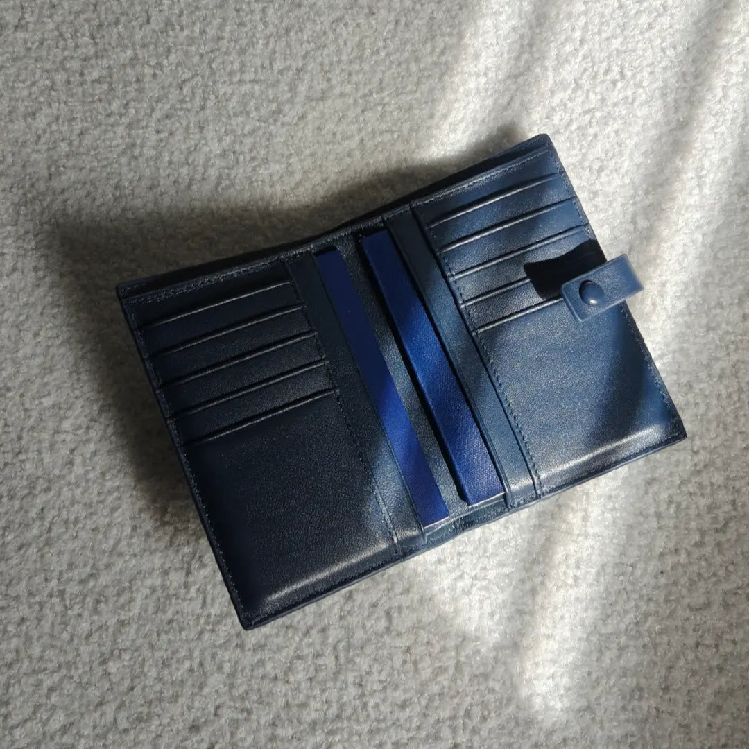 Blue leather wallet on a textured gray surface