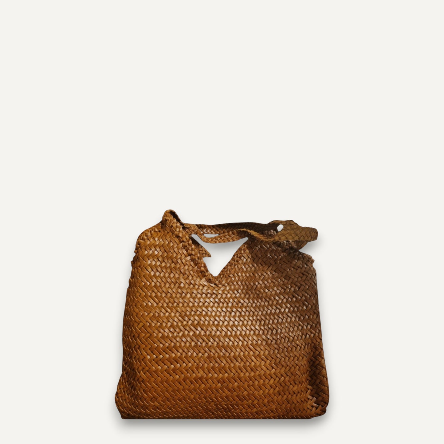 Brown top layer cowhide leather woven bag with soft, durable texture and braided handles