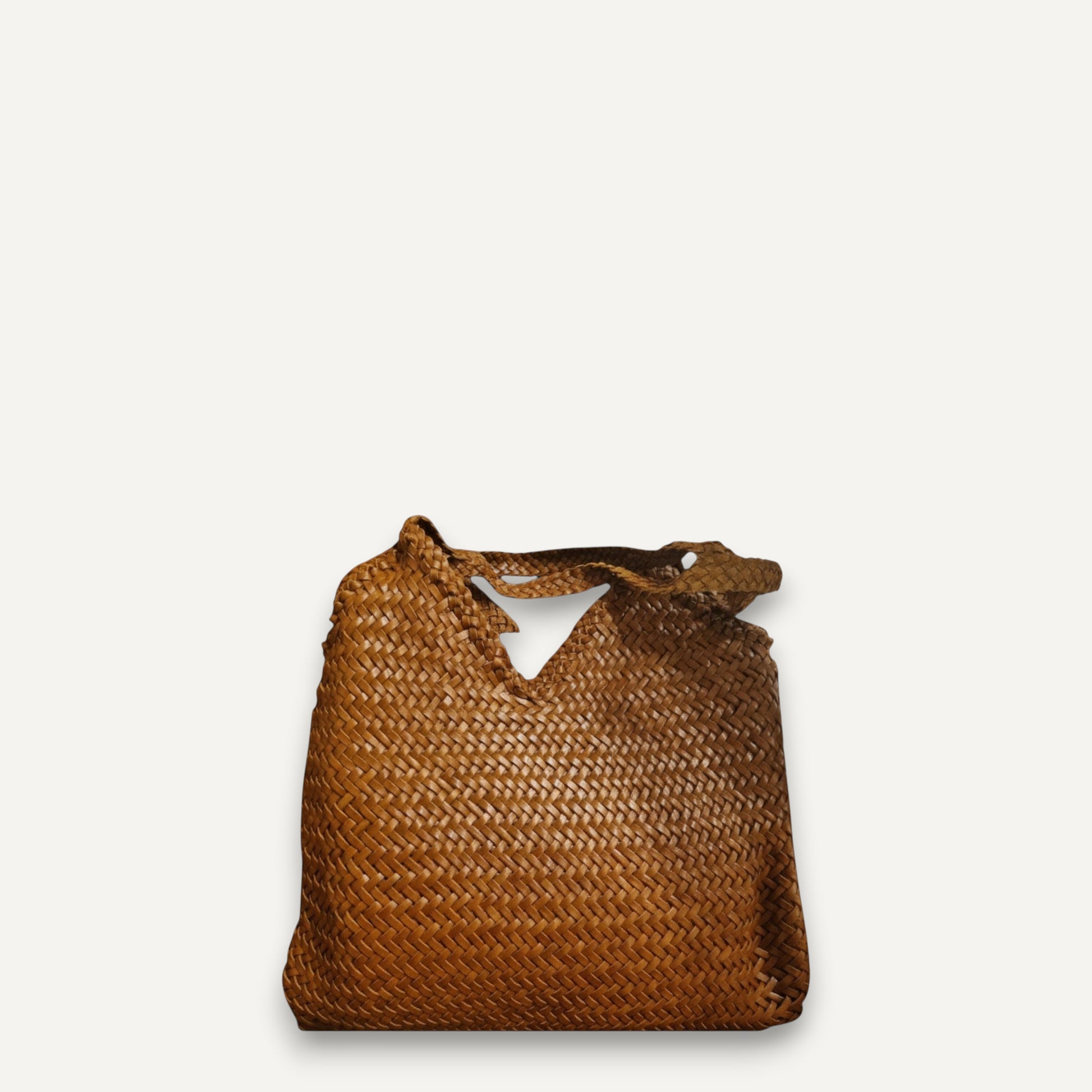Brown top layer cowhide leather woven bag with soft, durable texture and braided handles