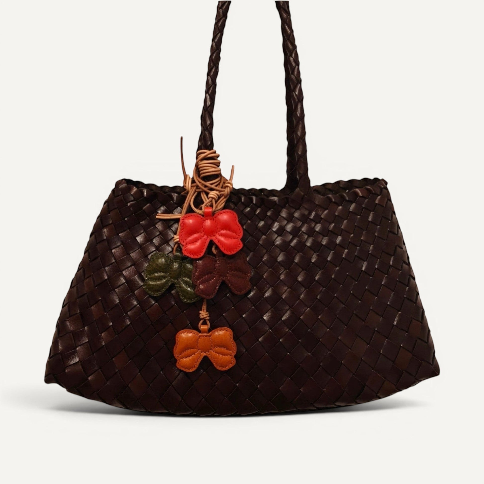 Handmade butterfly charm crafted from full-grain leather with detailed stitching and natural texture