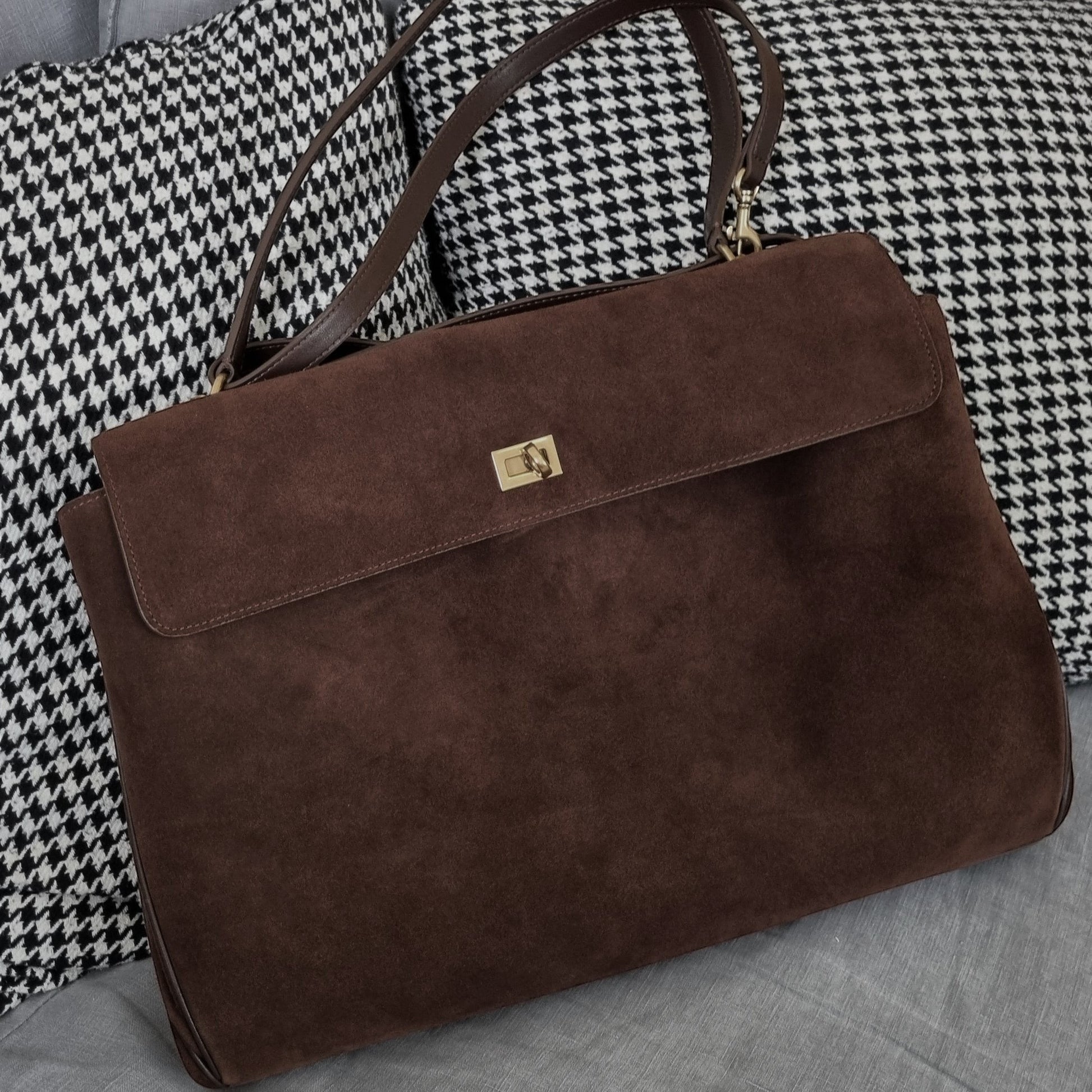 Harper large brown suede leather shoulder bag with gold-tone clasp on houndstooth and gray fabric background