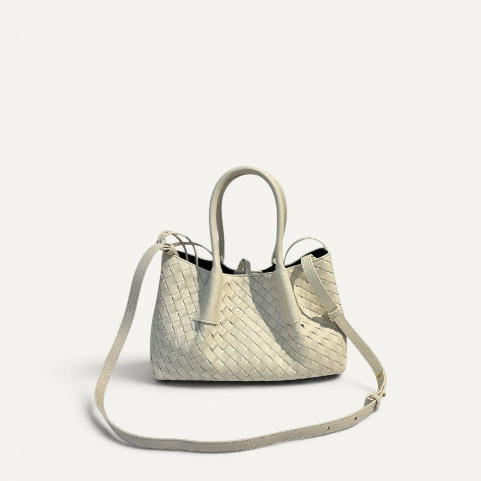 White woven handbag with a shoulder strap on a white background